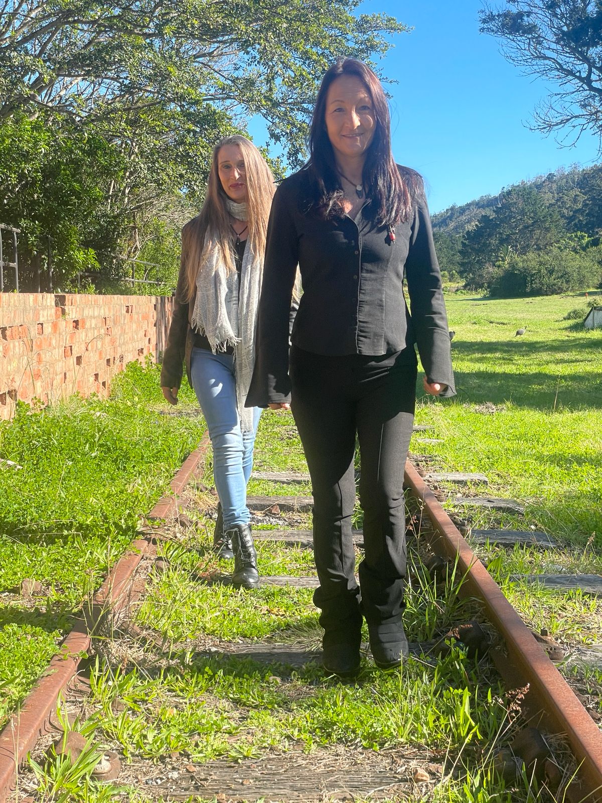 Tracey and Lindie walking towards the camera outdoors