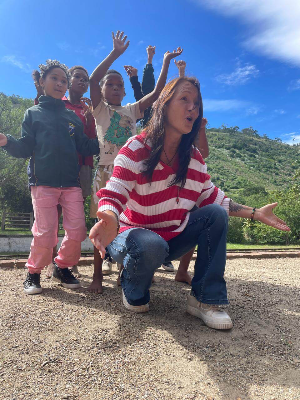 Tracey sharing a joyful music moment with children